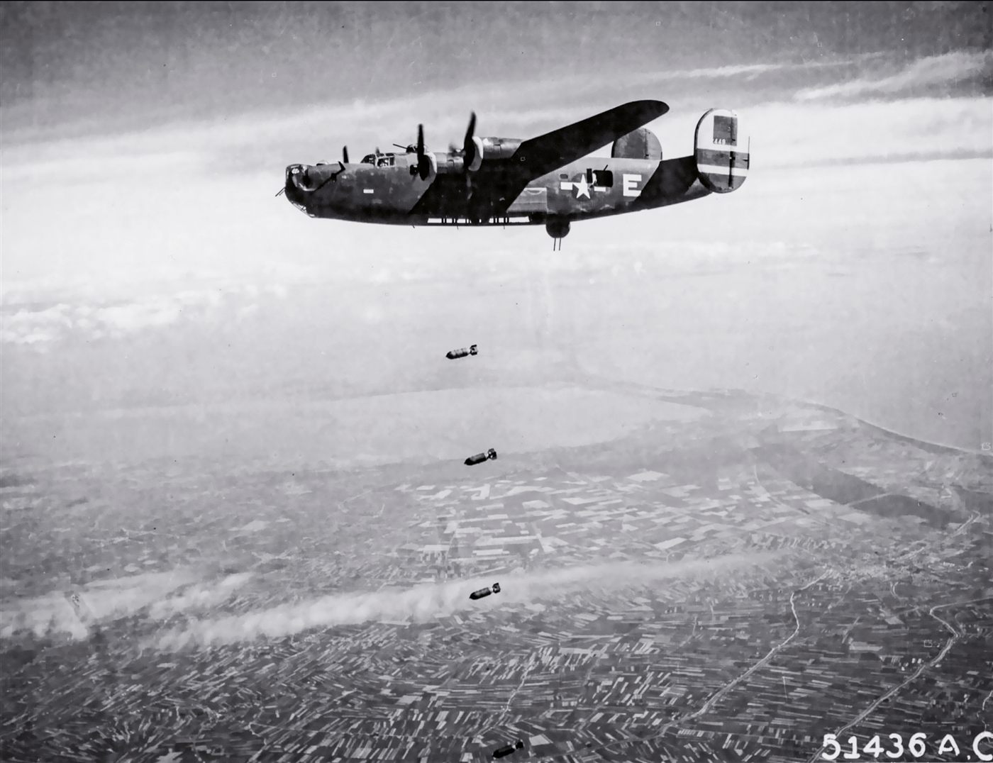 A B-24 Liberator of the 783rd Bomb Squadron flying over rail yards at Forlì, Italy, May 1944.